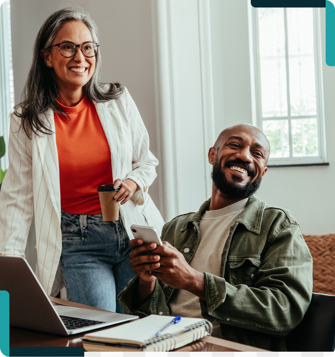 Smiling colleagues with laptop and phone